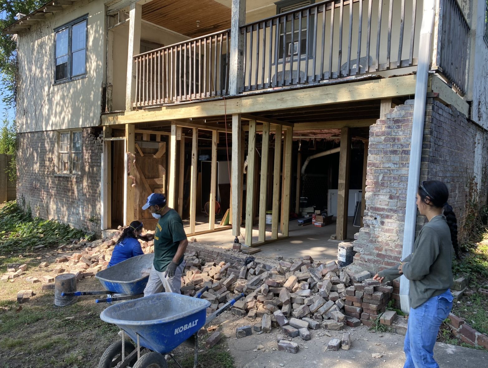 Temporary supports hold up house while new foundation footer is poured