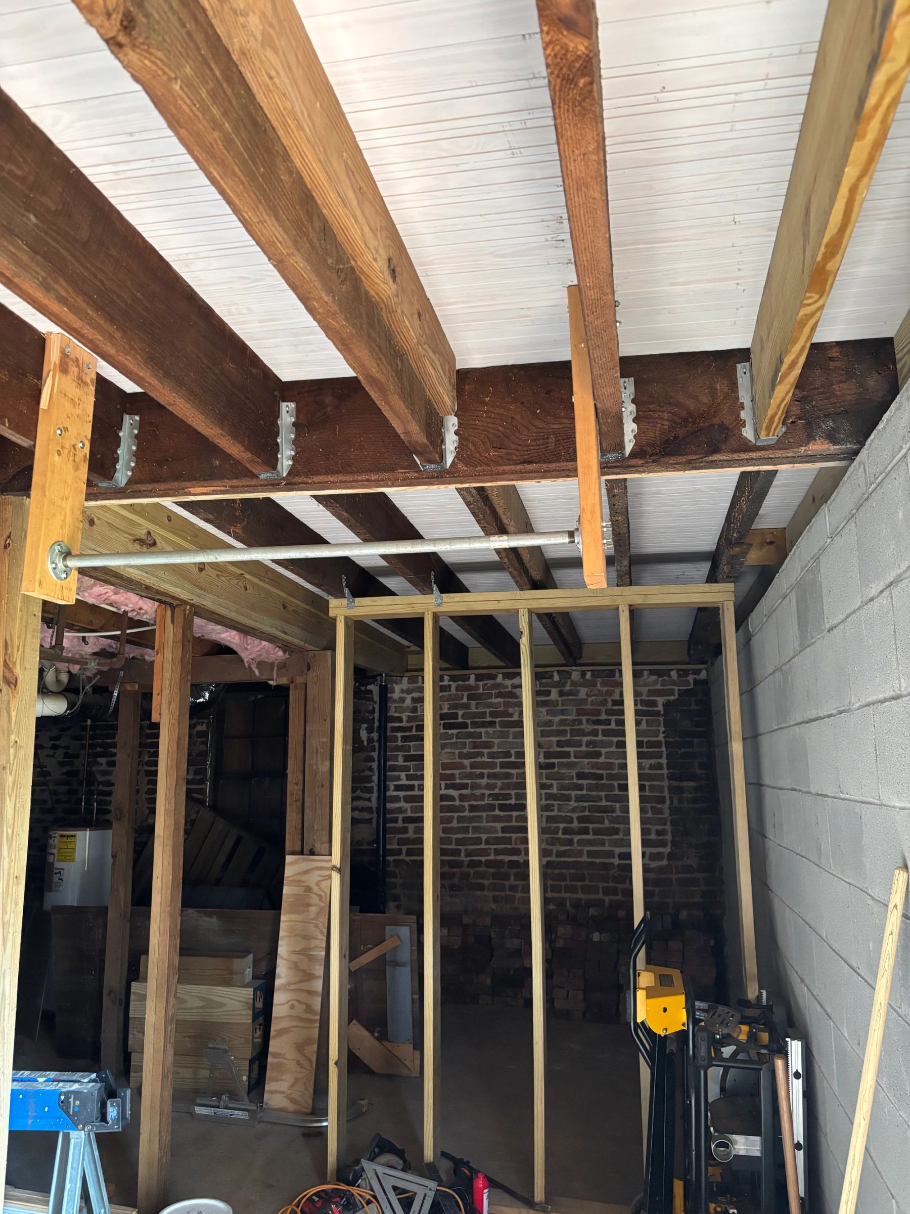 Newly installed 3 1/4" primed floor boards on porch and properly fastened floor joists